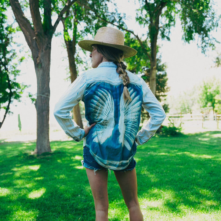Jillian, known as The Noisy Plume, wearing Olivia Poyer’s iconic cyanotype pheasant wing shirt — artistic fashion meets sustainable design.