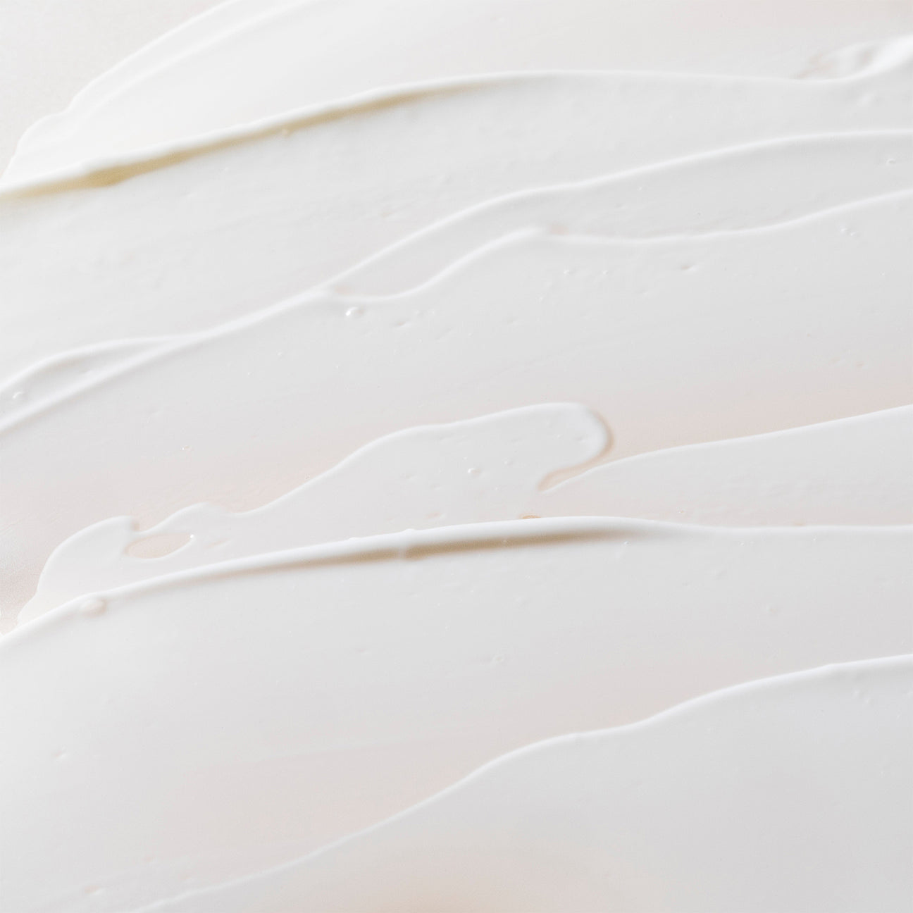 Close-up texture of Crunchi Daylight Facial Cream smeared across a neutral background — clean, minimal, and elegant skincare backdrop.