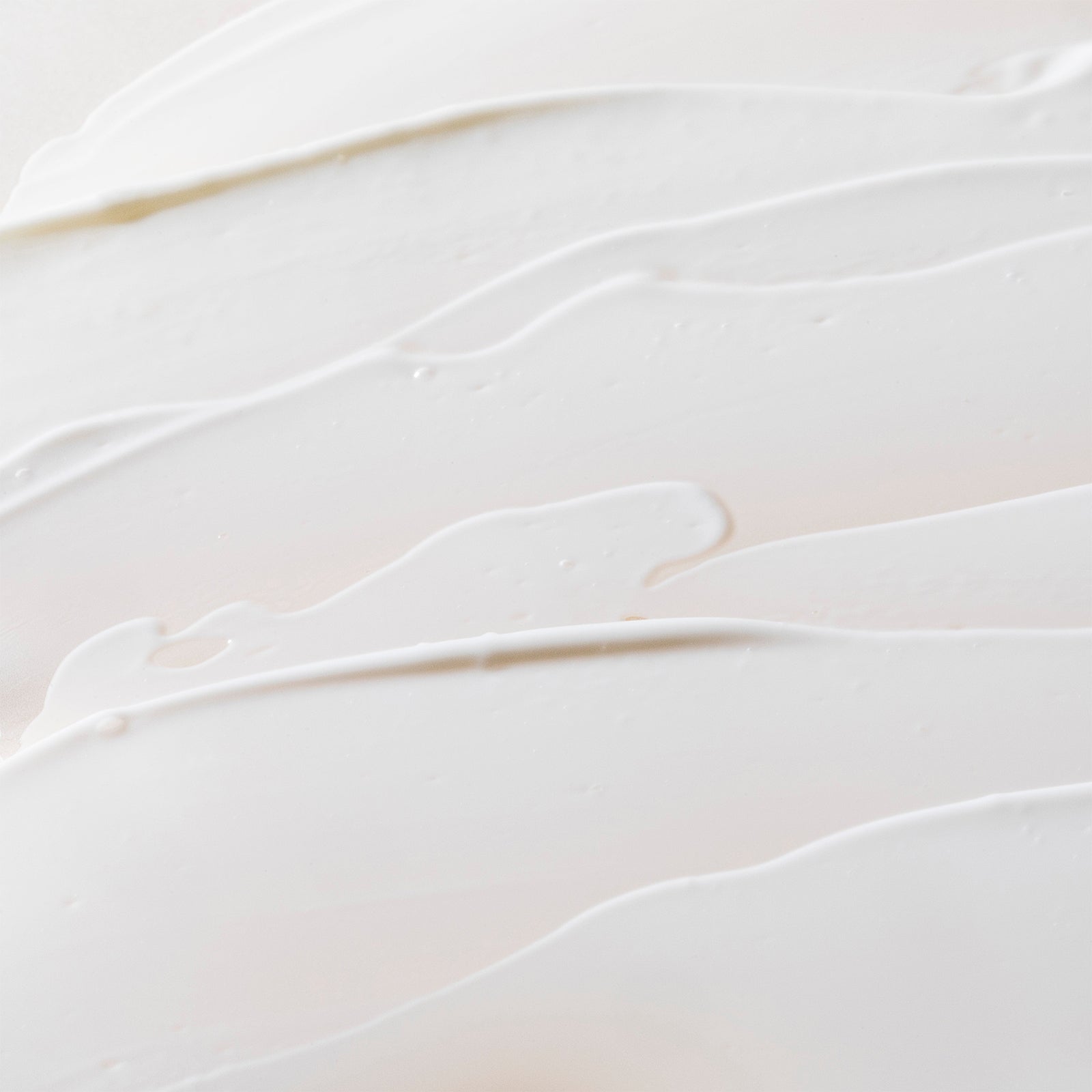 Close-up texture of Crunchi Daylight Facial Cream smeared across a neutral background — clean, minimal, and elegant skincare backdrop.