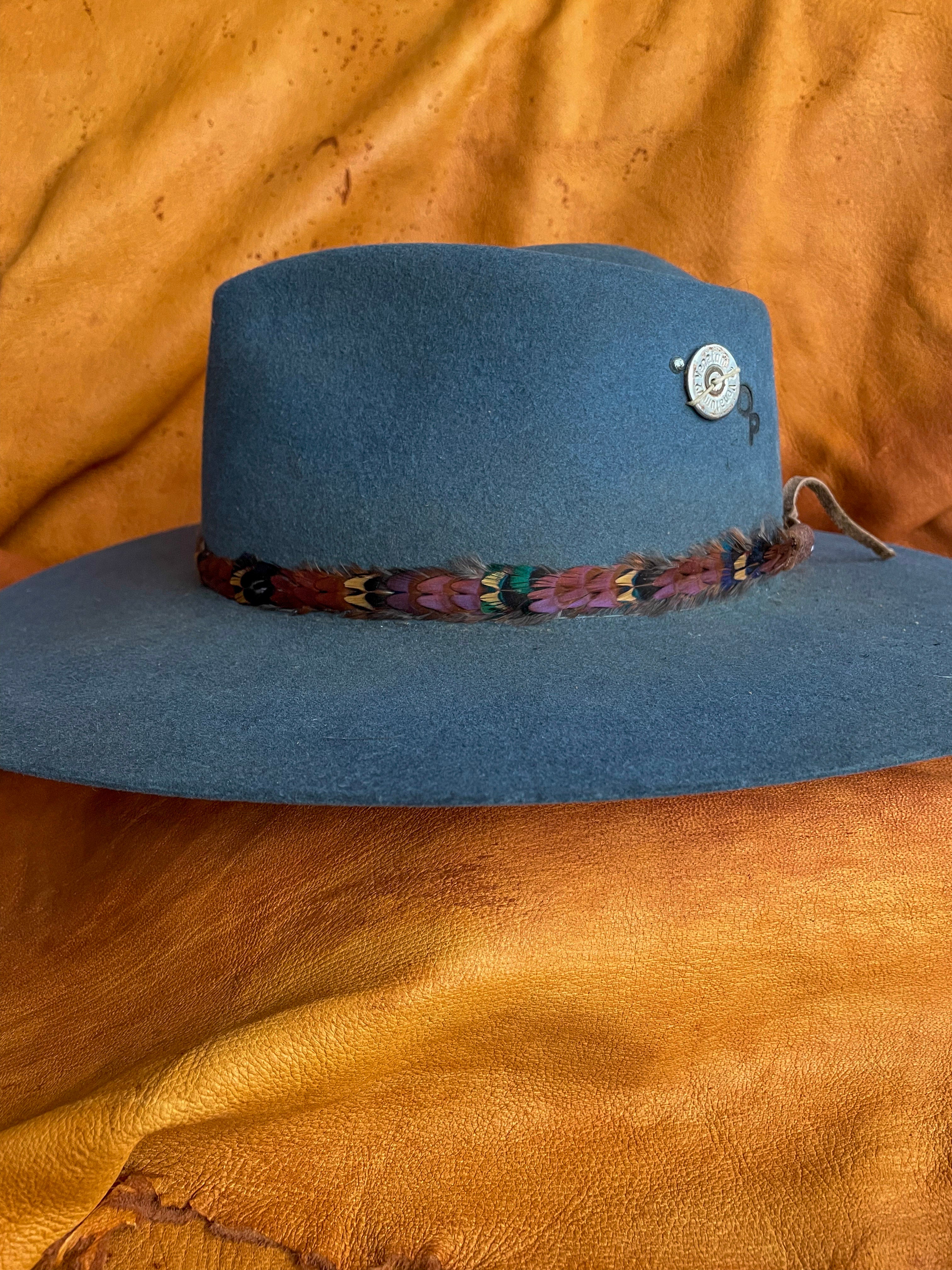 Handmade pheasant feather hatband on a steel blue hat.