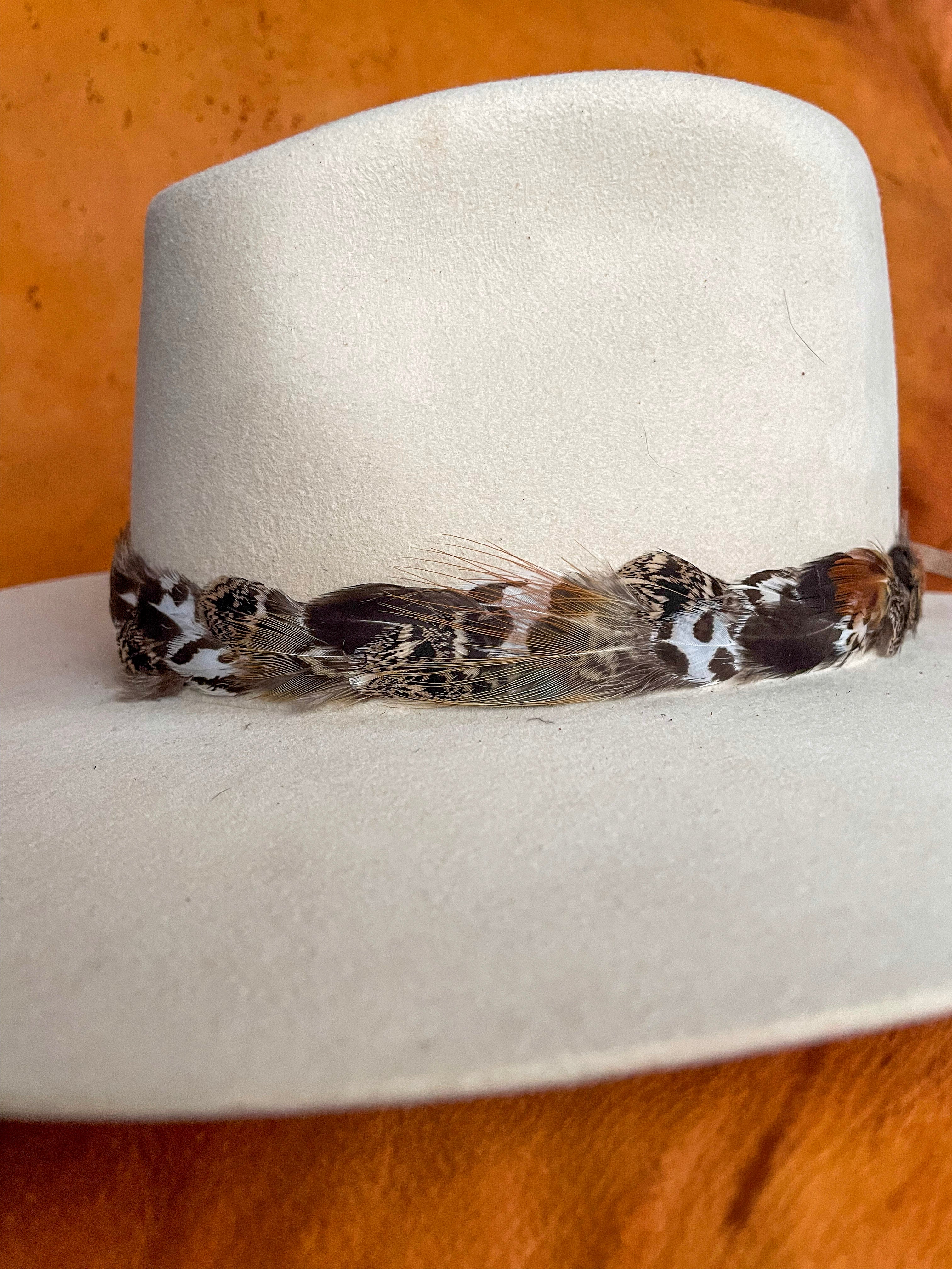 One-of-a-kind feather band inspired by natural landscapes.