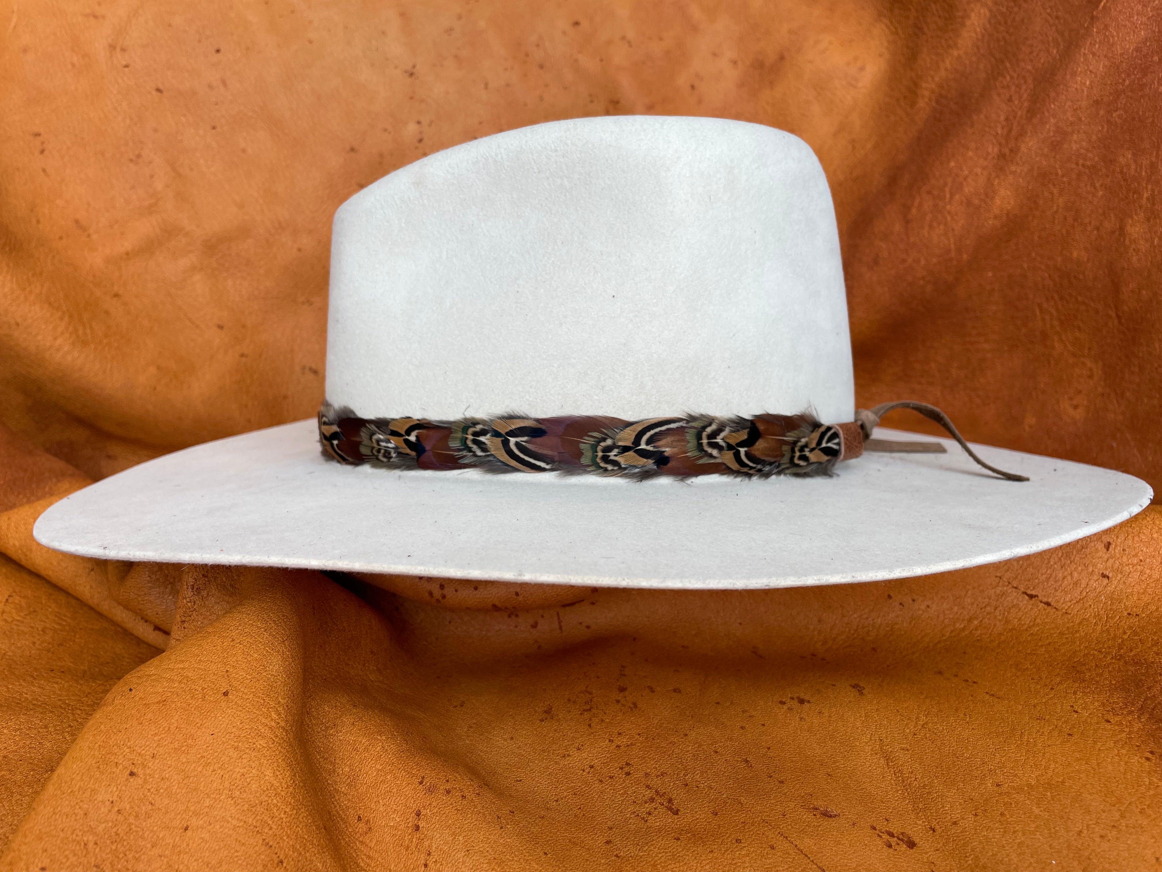 Isolde patterned pheasant feather hatband on cream hat