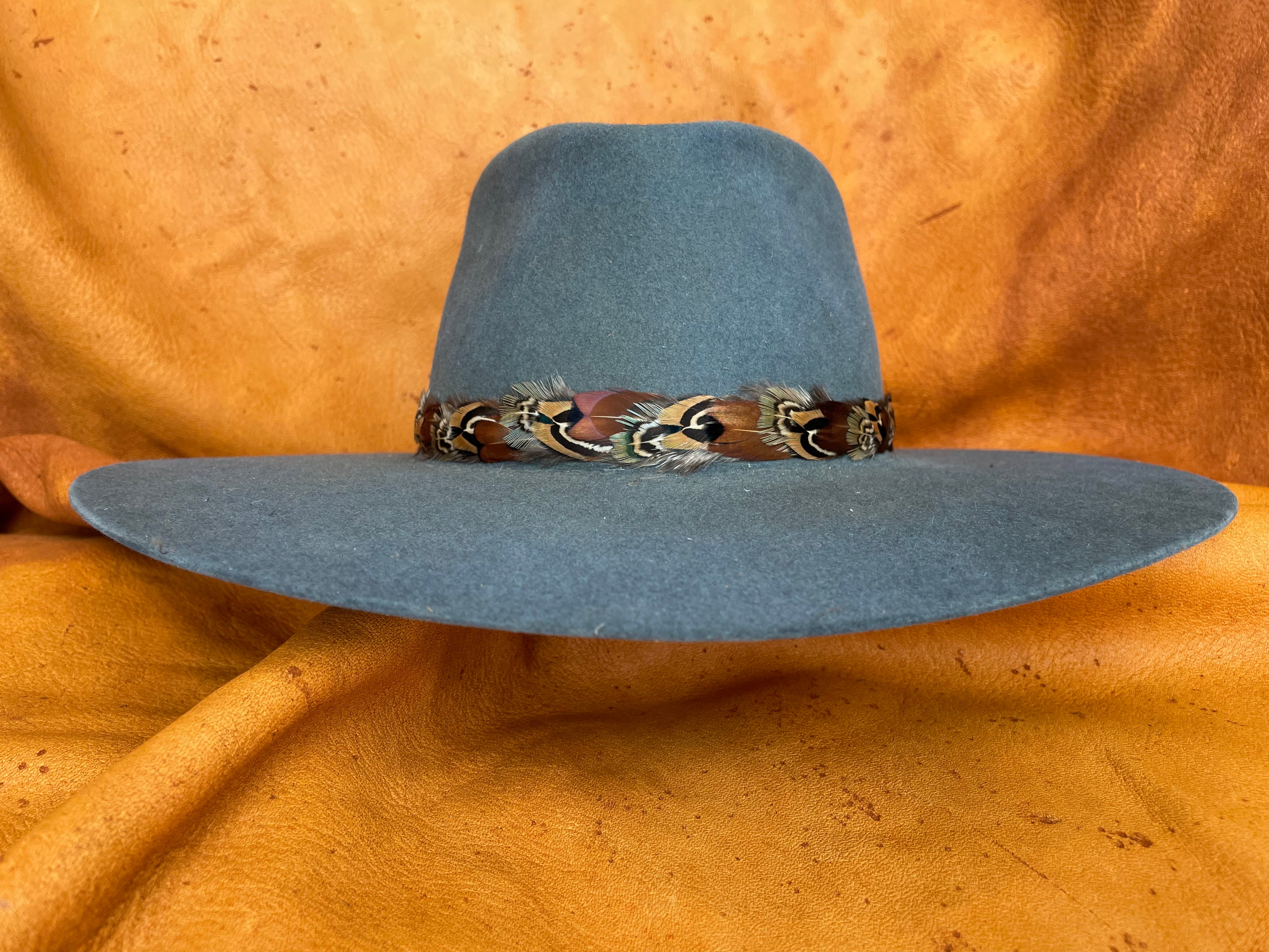 Feather pattern detail on grey/teal hat