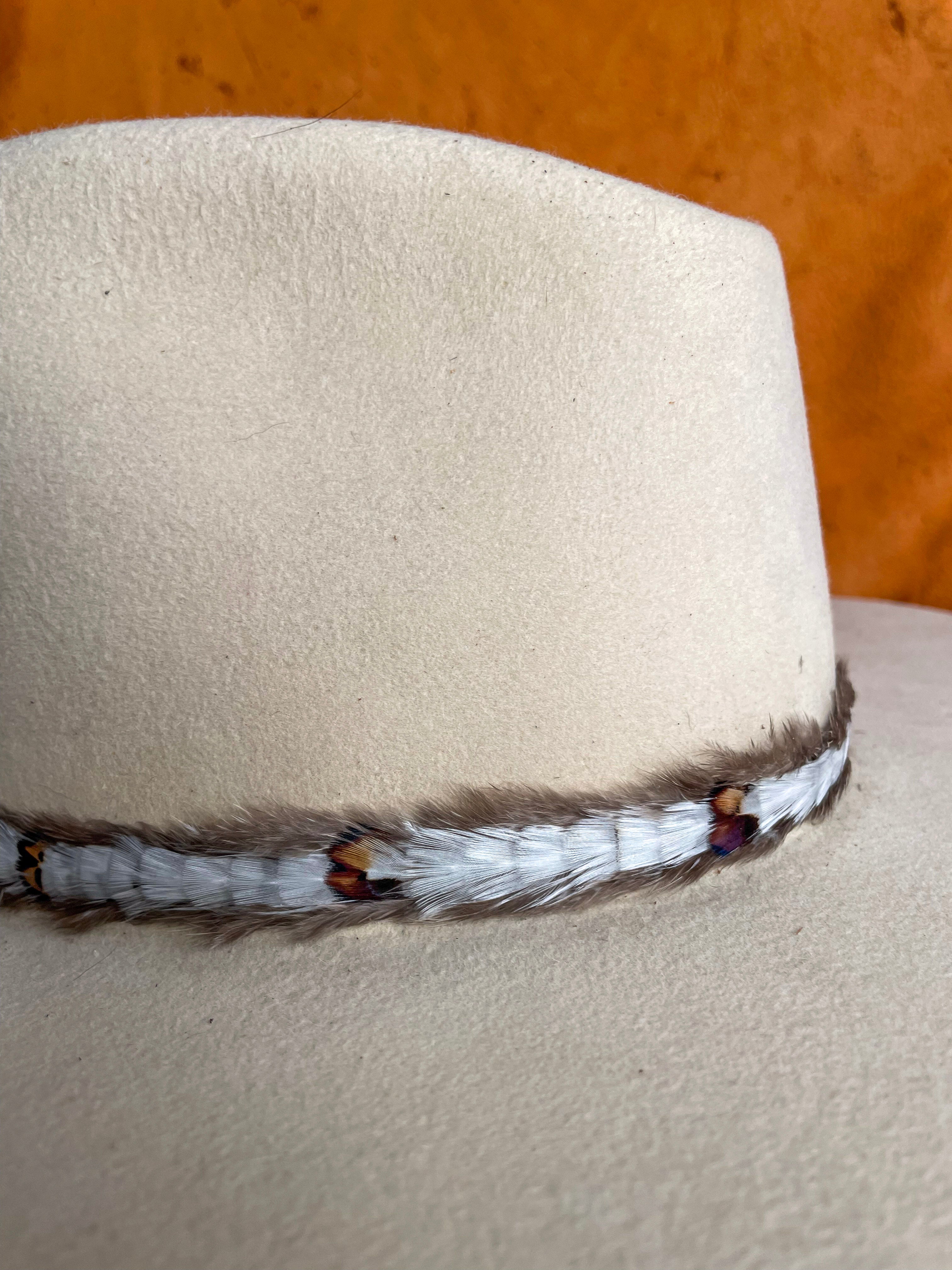 Close-up of ivory feather band with natural patterns.