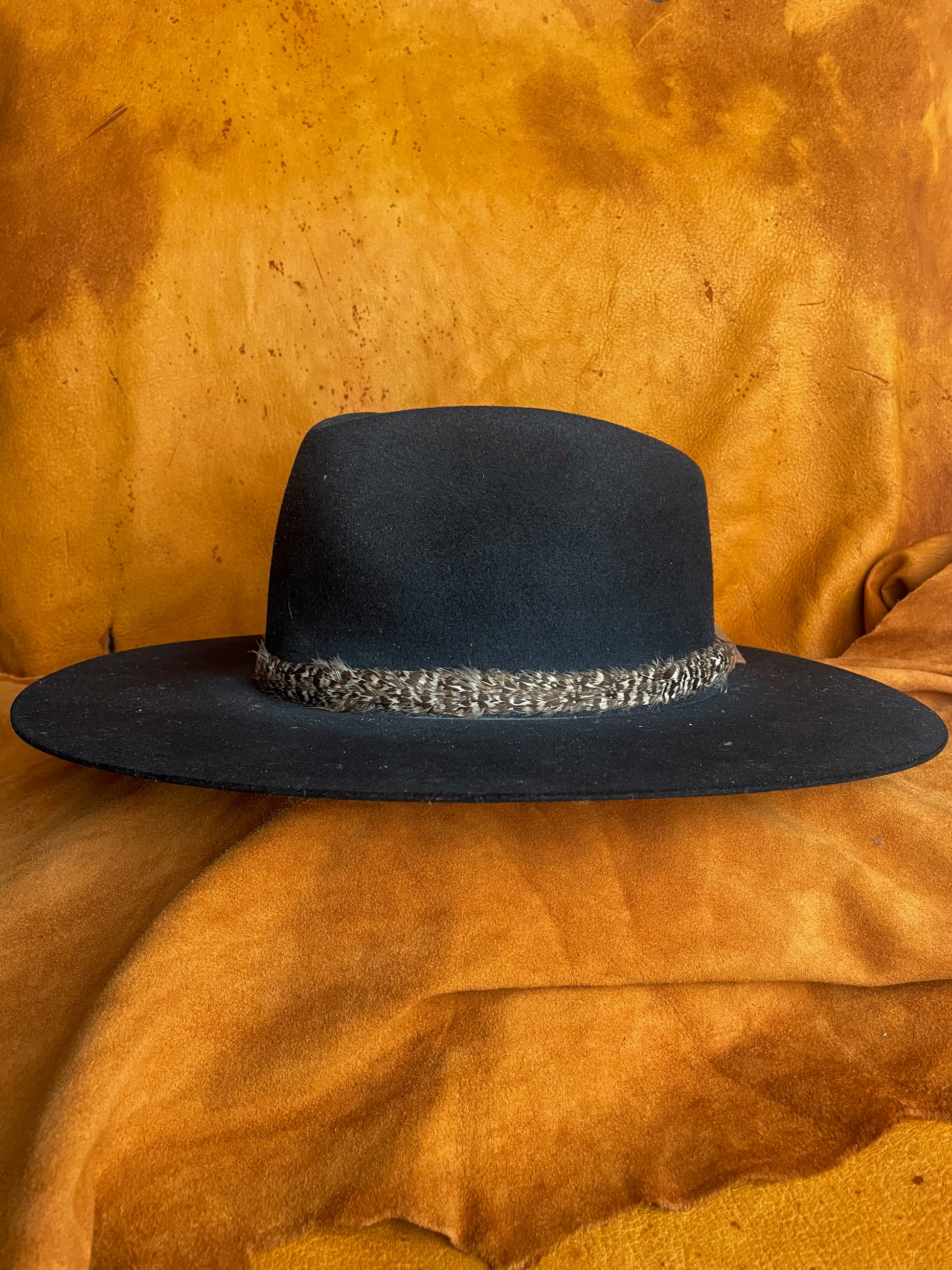 One-of-a-kind feather band inspired by prairie landscapes.