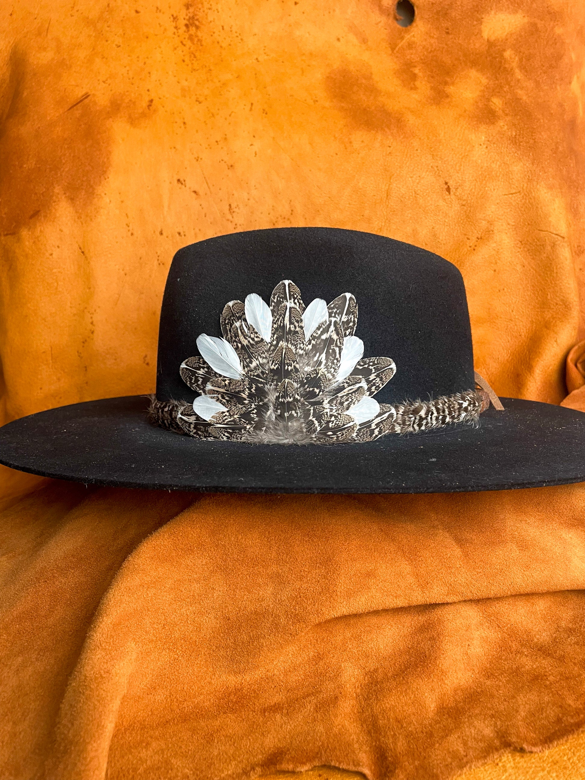 Handmade feather hatband and medallion with sage grouse feathers.
