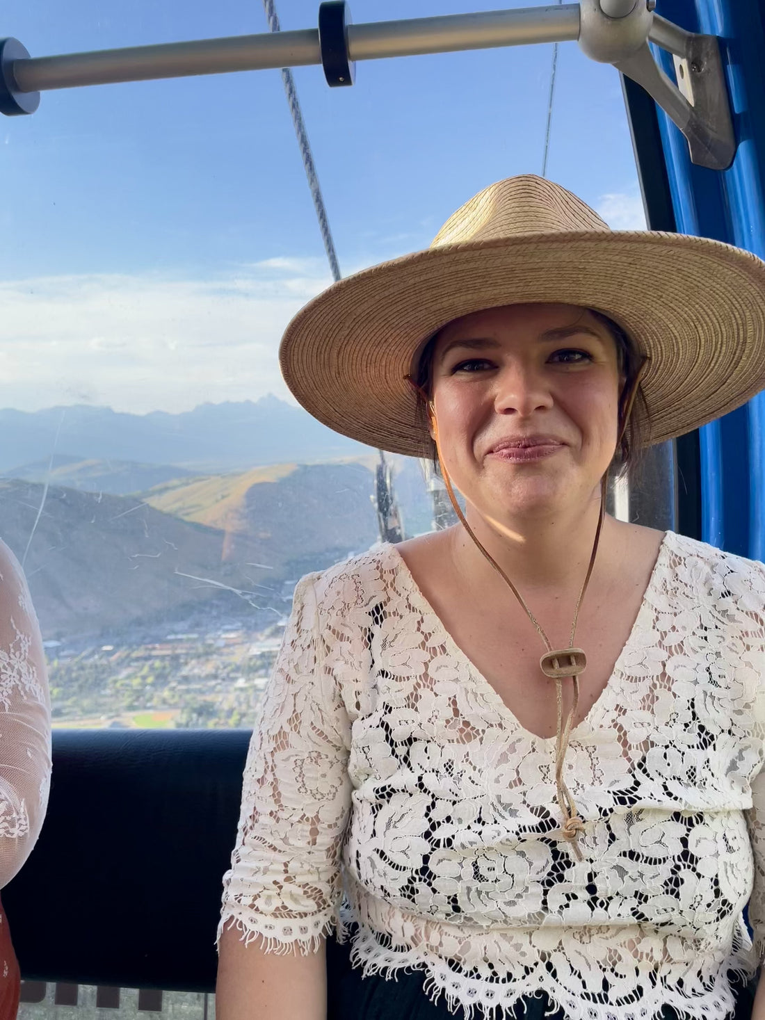 Olivia Poyer smiling on gondola ride up Snow King Mountain — representing intentional living and natural beauty.