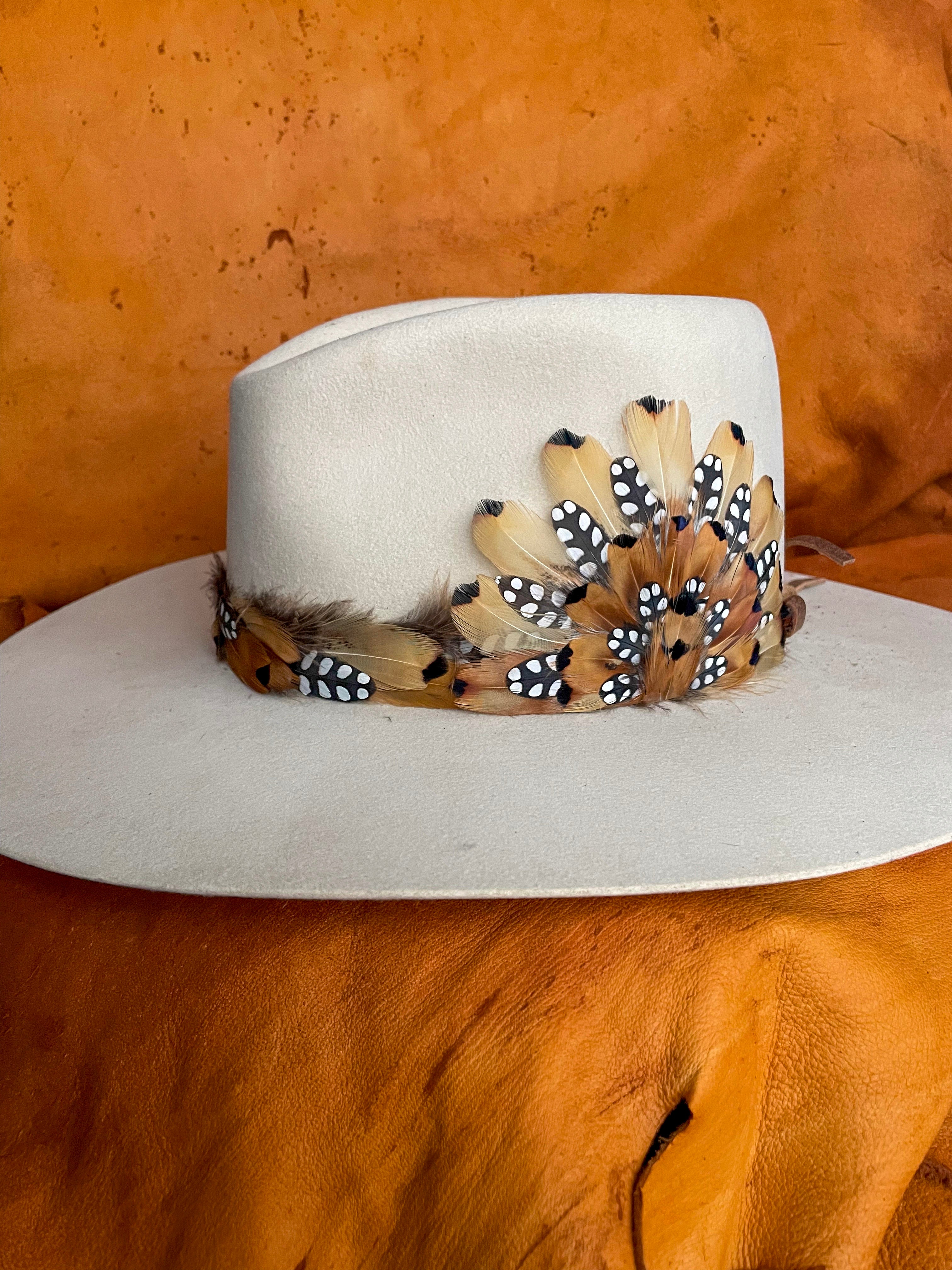 Handmade feather hatband and magentic medallion with golden pheasant and quail feathers with black polka dot accents.