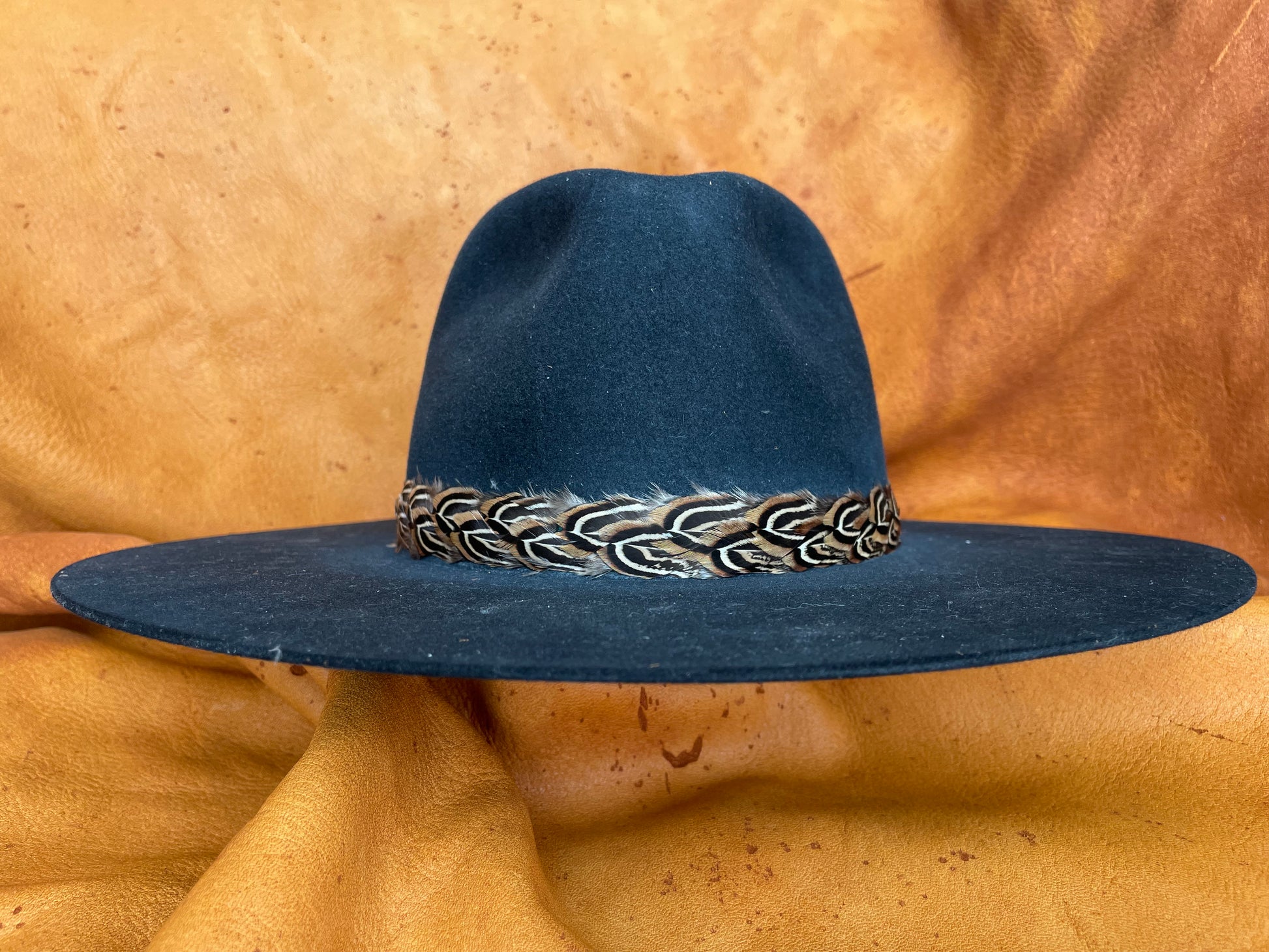 Sutton golden pheasant feather hatband on black hat, front view