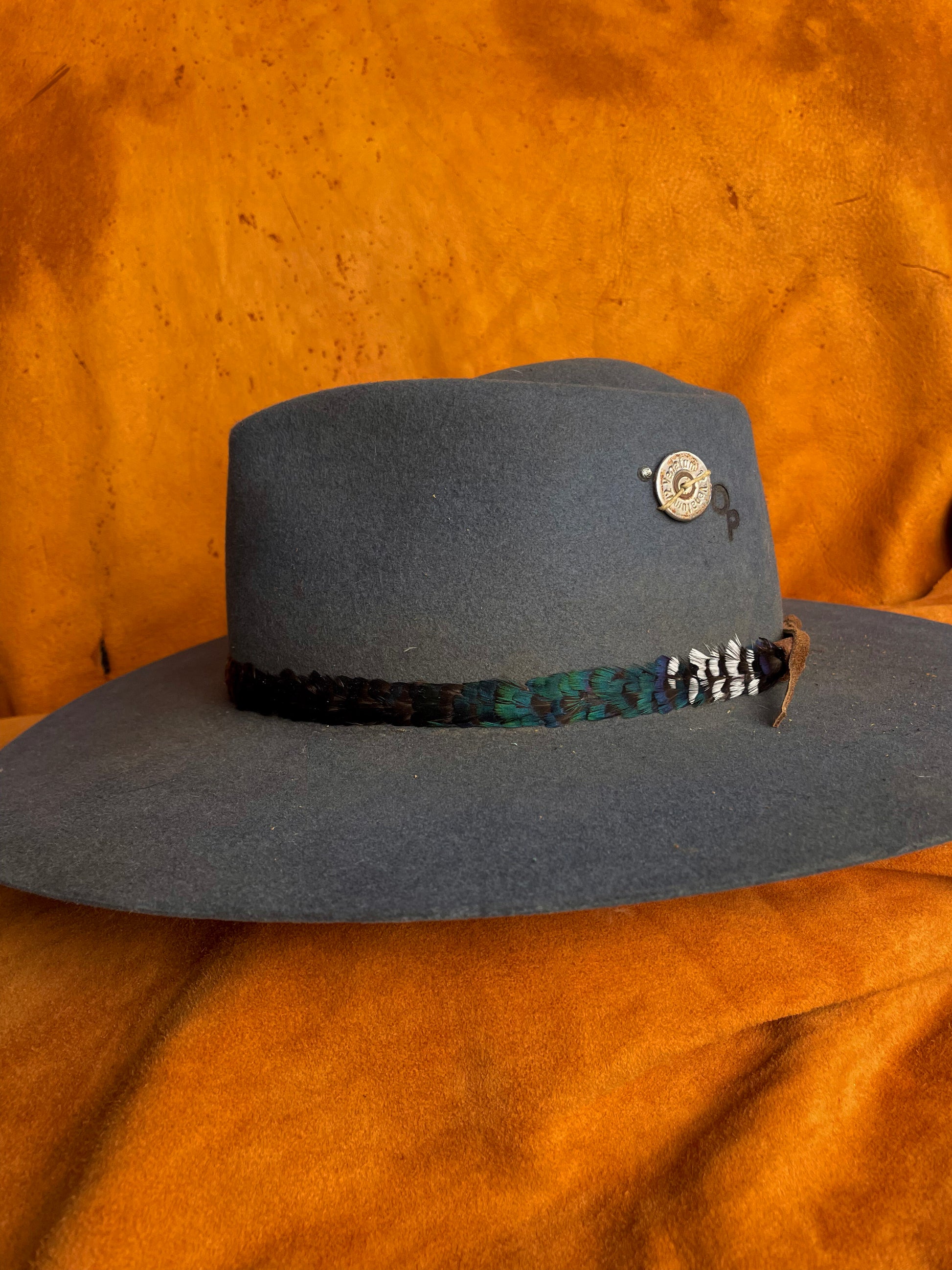 An emerald green color block on a pheasant feather hatband. 