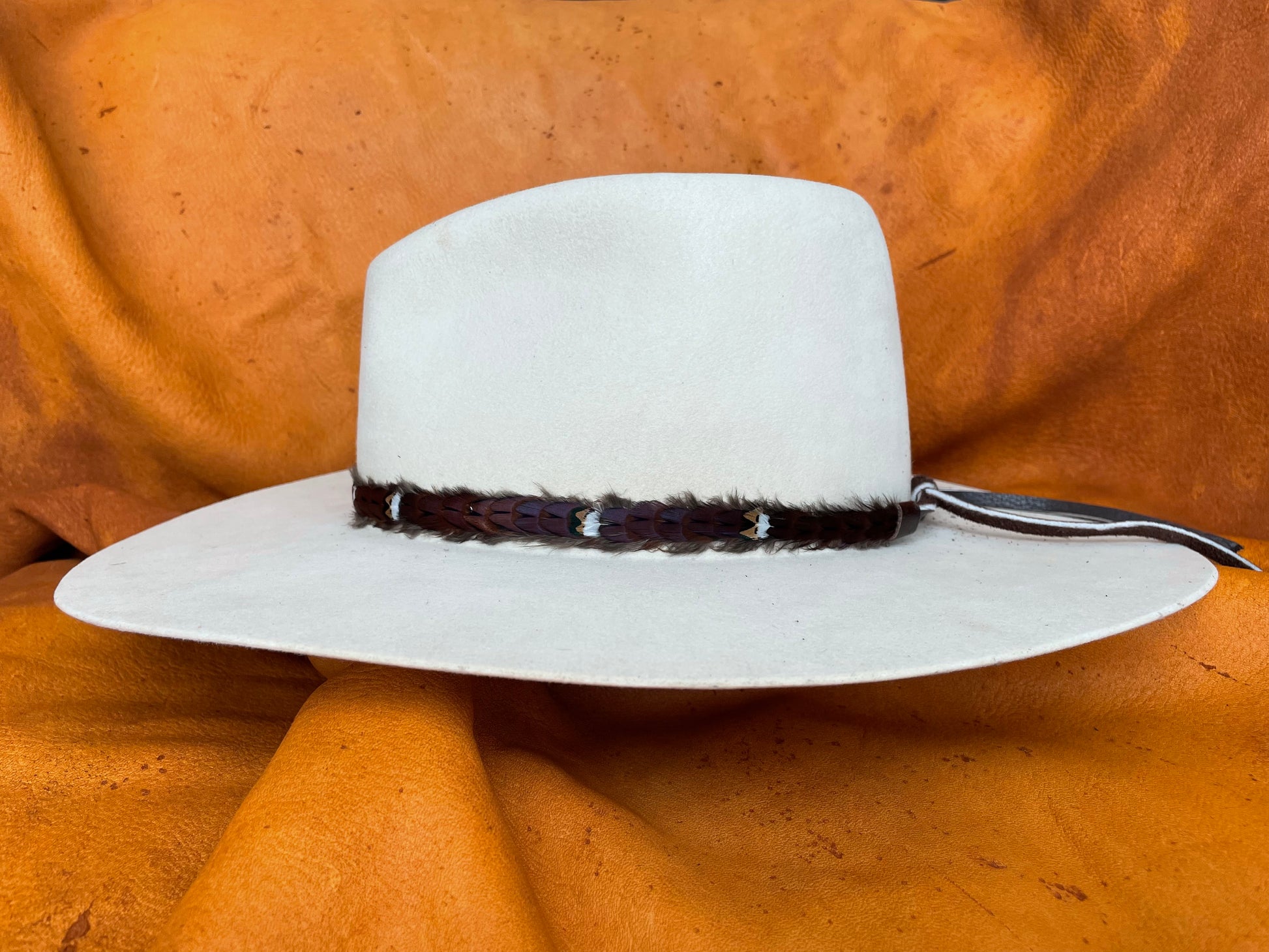 Willa maroon pheasant feather hatband on cream hat, side view