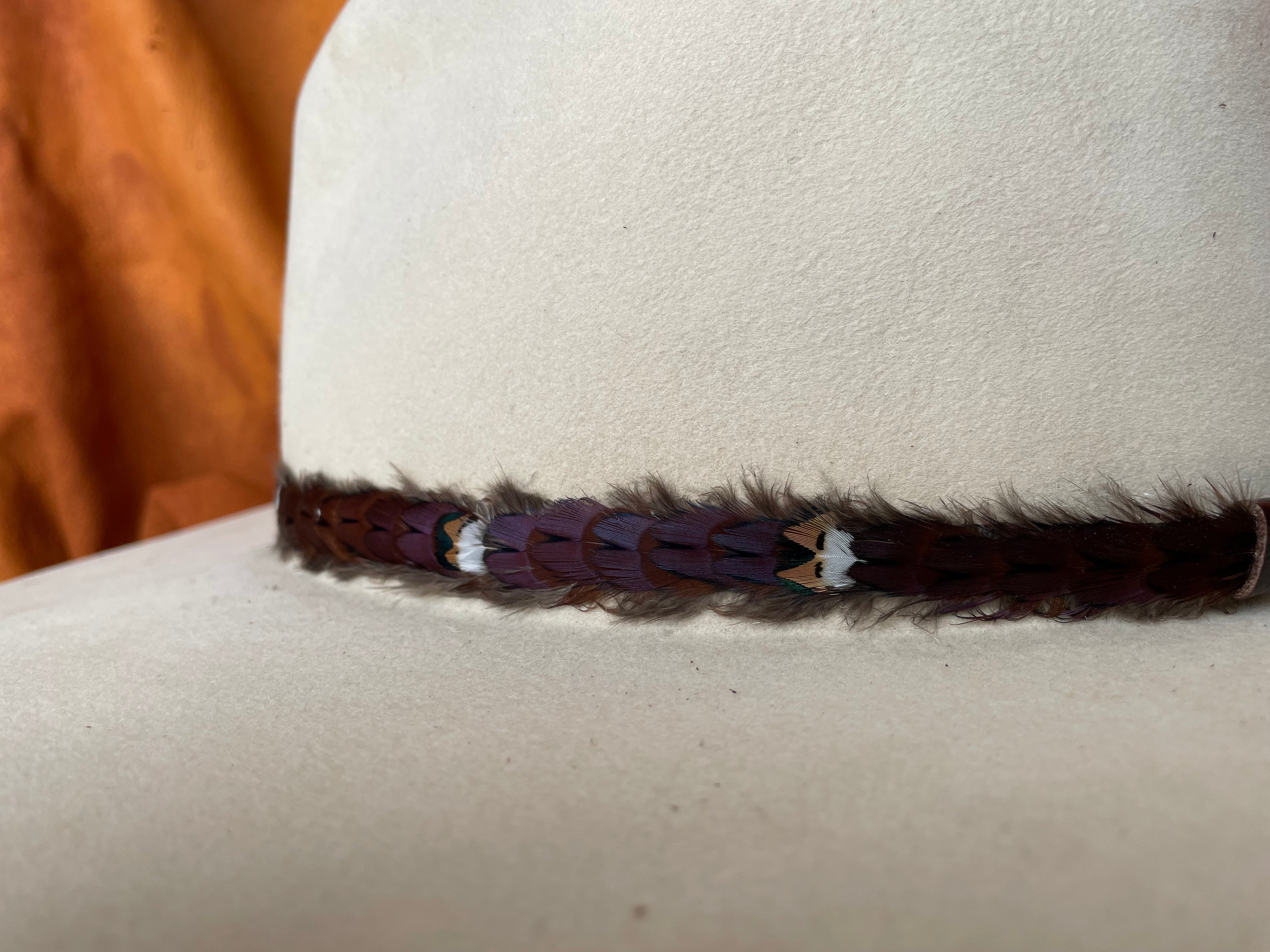 Close-up of Willa feather hatband showing natural sheen
