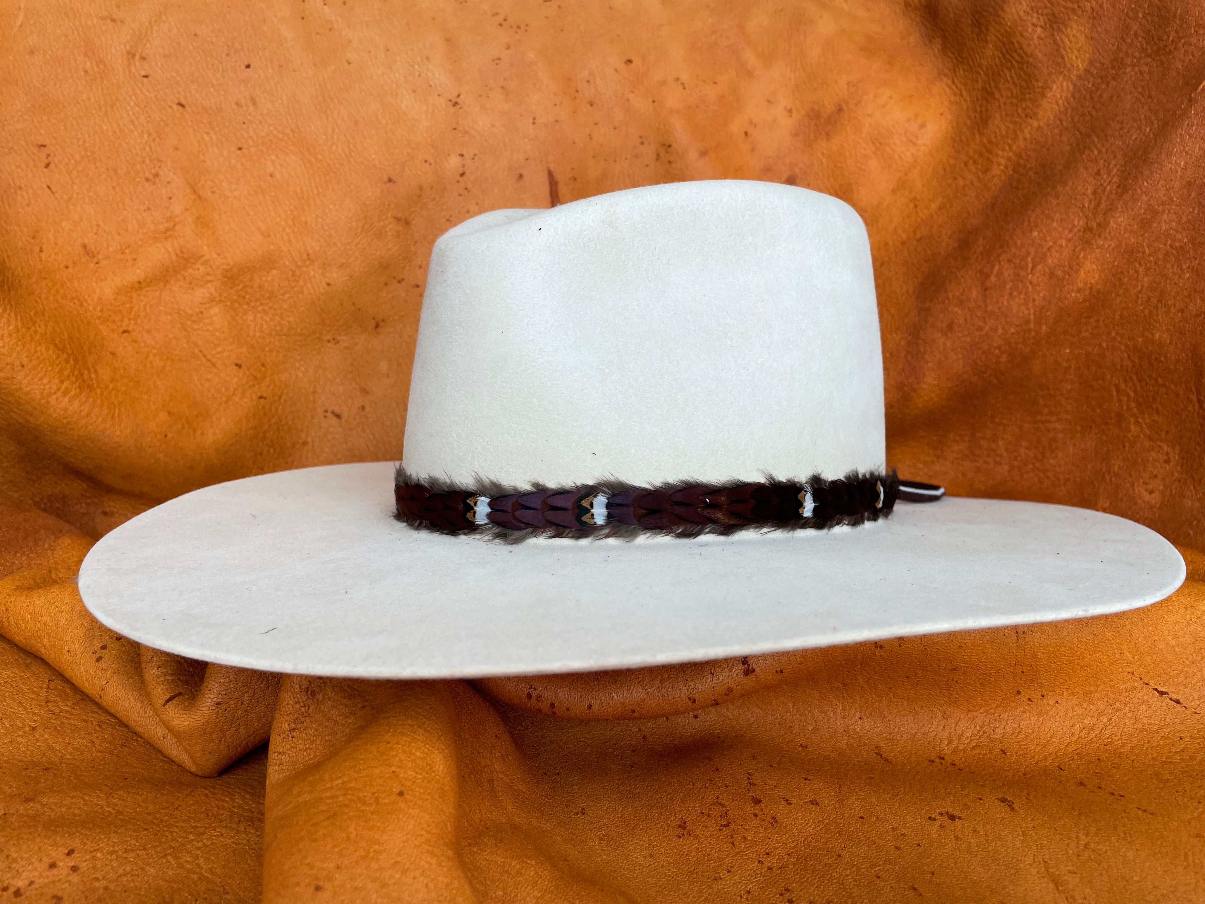 Maroon feather hatband with golden accents, angled