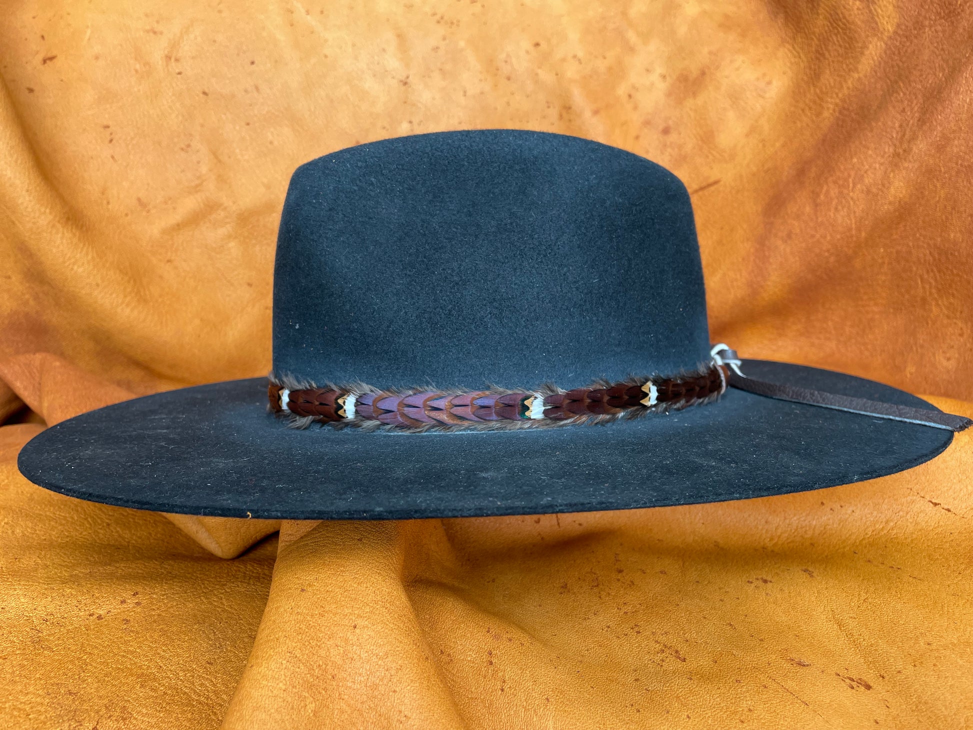 Feather hatband on teal/grey hat, side angle